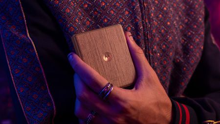 Close up of a Motorola Razr being held in a ring fingered hand